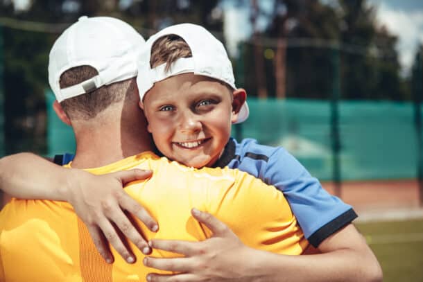 Smiling boy hugging father